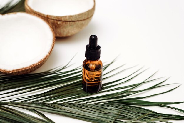 Bottle with pipette of organic coconut oil or serum on a white background Skin care antiaging