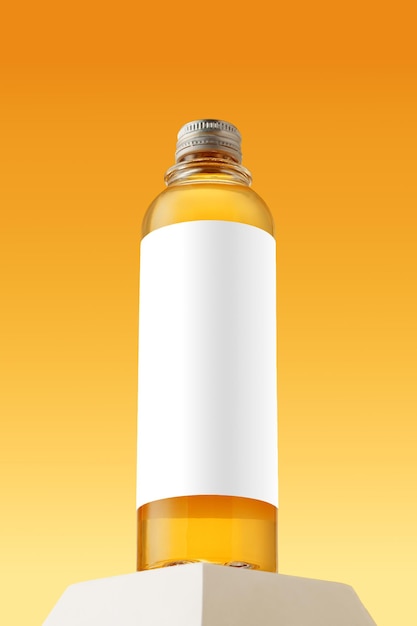 Bottle with skincare oil against yellow background