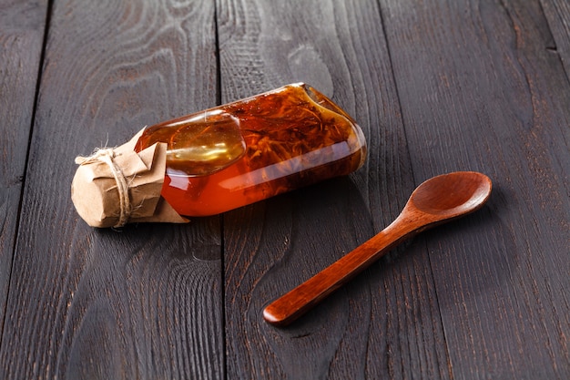 Bottle with vegetable oil with herbs on wood rustic table