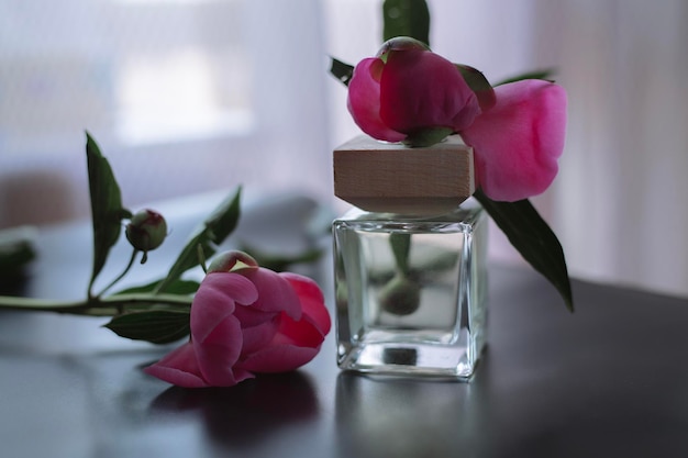 Bottle of women's perfume and flowers