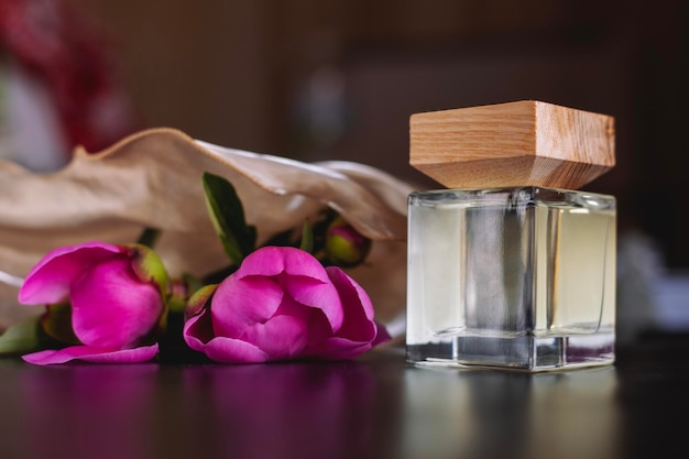 Bottle of women's perfume and flowers