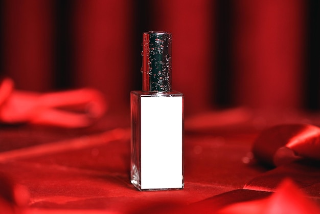 Photo bottle of womens perfume on a red background with mockup the concept of beauty