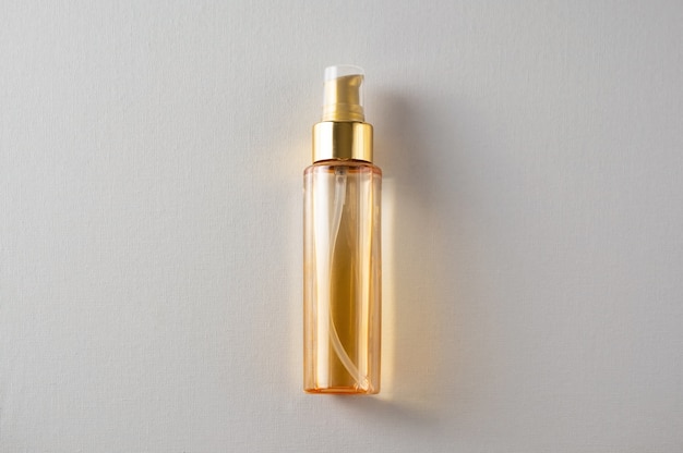 The bottle of yellow cosmetic oil