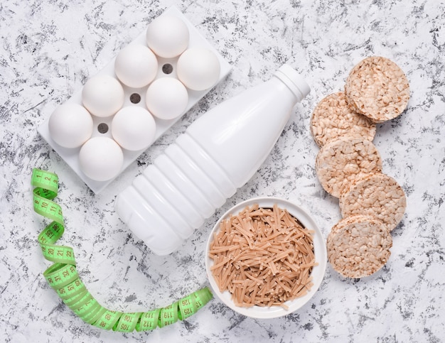 Bottle of yogurt, crispy round bread, buckwheat noodles, oatmeal and eggs