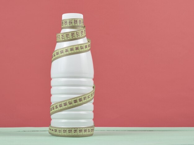 Bottle of yogurt wrapped in a ruler