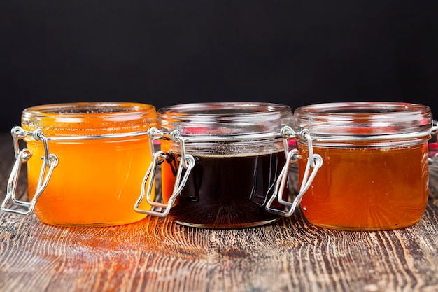 Bottled in different jars several different types of honey that differ in color