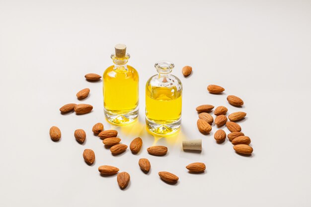 Bottles of almond oil and almonds , copyspace.