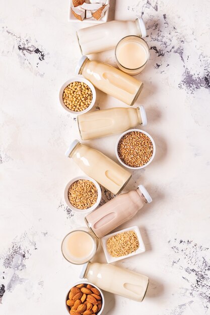 A bottles of alternative  milk and ingredients, top view.