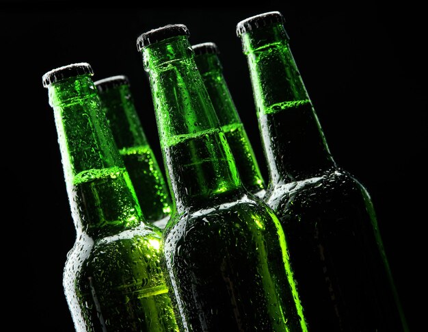 Bottles of beer on black background