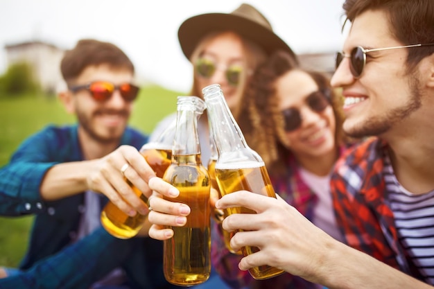 bottles of beer group of friends enjoying partypeople are drinking beer and laughing