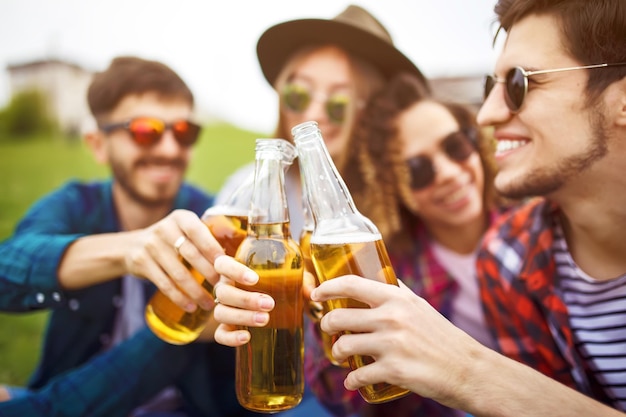 Bottles of beer Group of friends enjoying partypeople are drinking beer and laughing