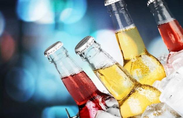 Bottles of cold and fresh beer with ice isolated