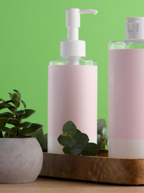 Bottles for cosmetics with a pink paper label on a green background Bottle for tonic