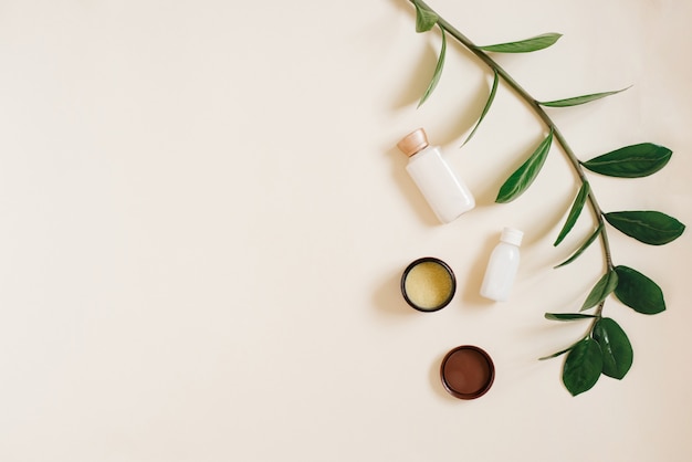 Bottles of creams on a beige background