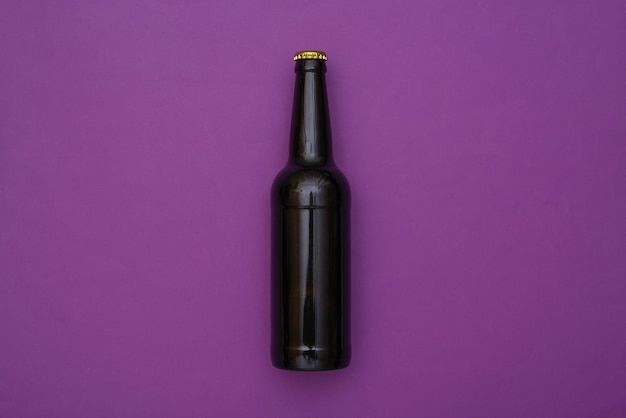 Bottles of dark beer on purple background. Top view