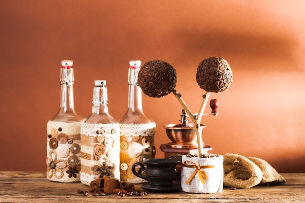 Bottles decorated with coffe beans, cinnamon and lace