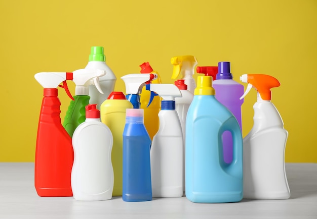 Bottles of different cleaning products on light table