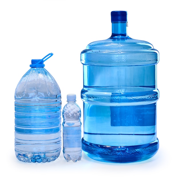 Premium Photo Bottles of different sizes with drinking water isolated