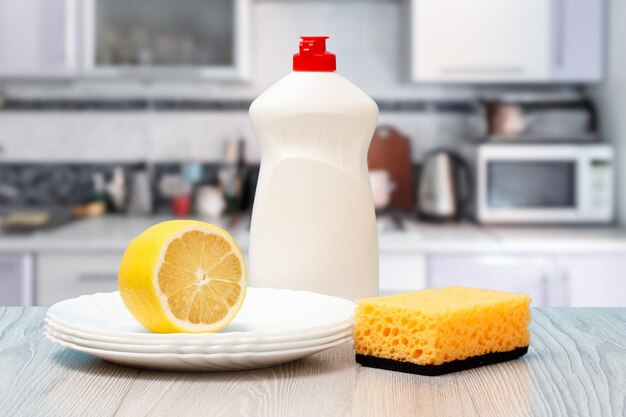  bottles of dishwashing liquid sponge plates and lemon