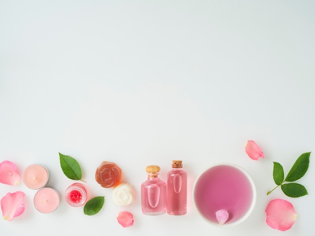 Bottles of essential oil and roses