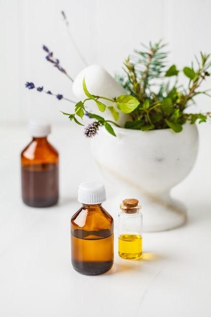 Bottles of essential oil, white background. Healthy cosmetics concept.