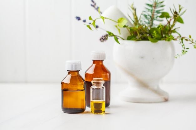 Bottles of essential oil, white background. Healthy cosmetics concept.