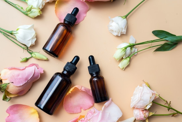 Bottles of essential oils and roses