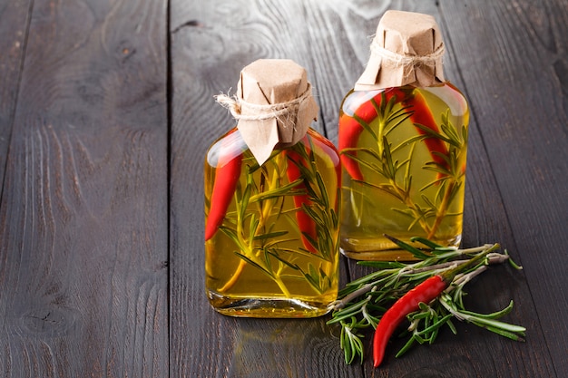 Bottles of extra virgin olive oil with aromatic herbs