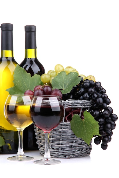 Bottles and glasses of wine and grapes in basket isolated on white