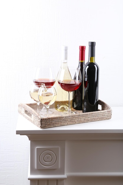 Photo bottles and glasses of wine on table in room