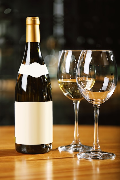 Bottles and glasses with wine on the table