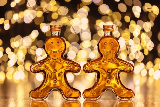 Photo bottles of homemade gingerbread syrup on light spotty background