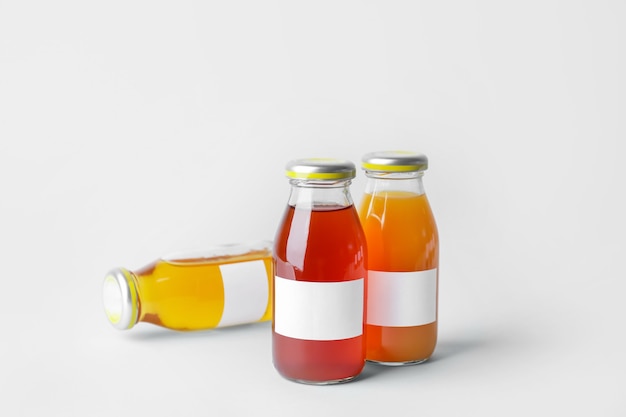 Photo bottles of juices on grey