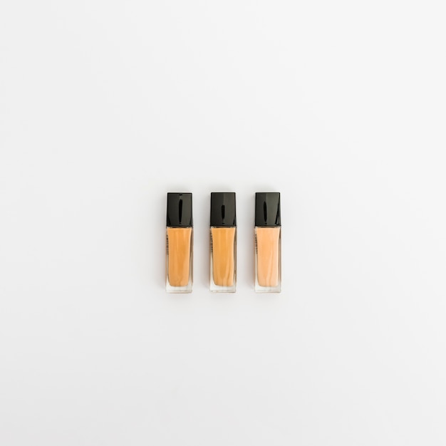 Bottles of liquid foundation on white background