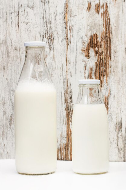 Bottles of milk on a wooden background