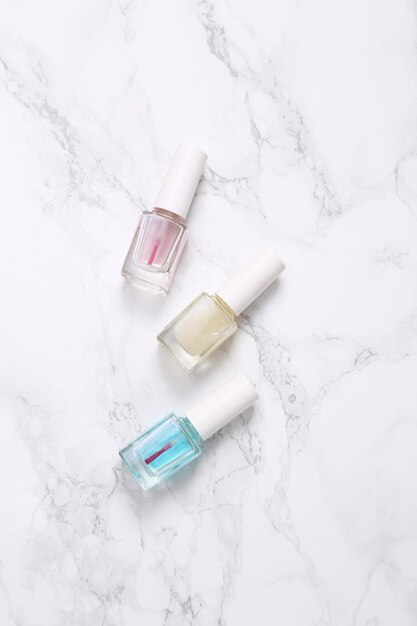 Bottles of nail polish on marble surface