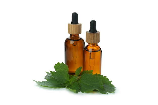 Bottles of nettle essence oil isolated on white