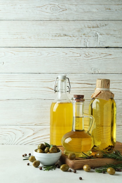 Bottles of olive oil against white wooden surface