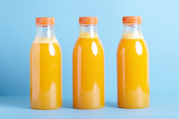 Photo bottles of organic orange juice