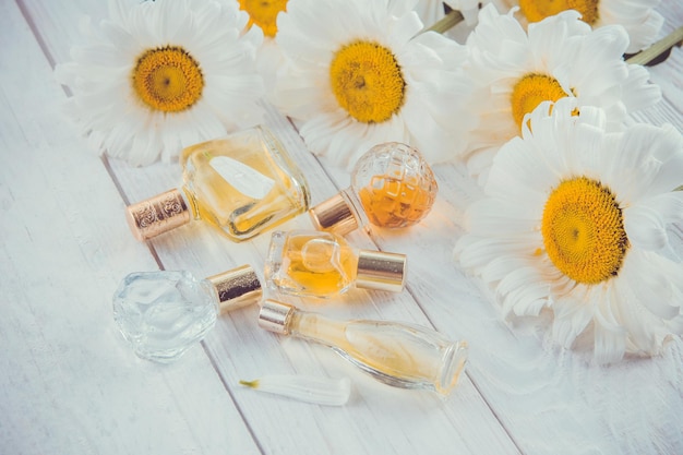 Bottles of perfume with camomile