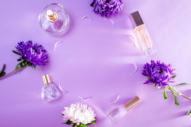 Bottles of perfume with purple and white flowers