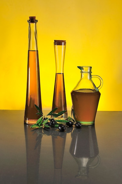 Bottles of virgin olive oil, with colored background.