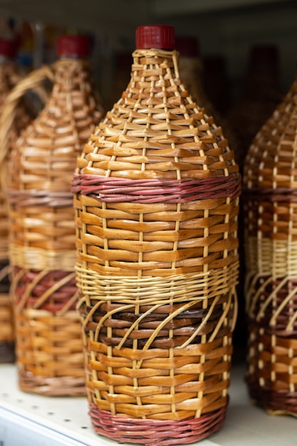 Bottles, wine jugs, jars braided with rattan wood vine