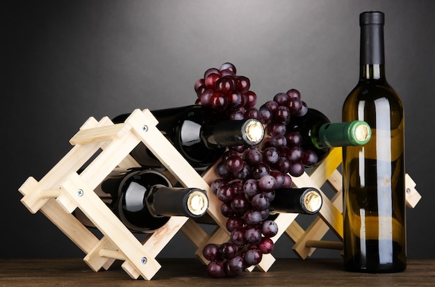 Bottles of wine placed on wooden stand