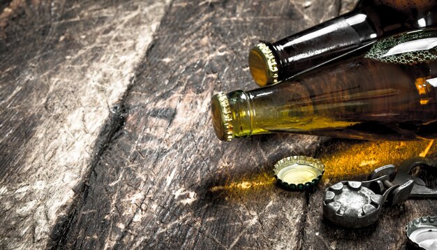 Bottles with fresh beer. On a wooden background.