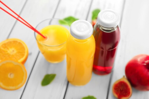 Photo bottles with fresh juices on table