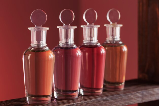 Bottles with magic potions on pink background