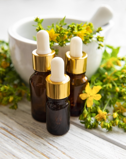 Bottles with St. John's wort extract on the wooden table