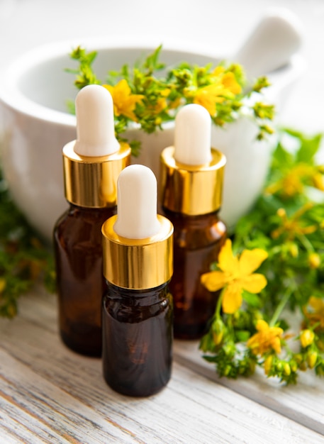 Bottles with St John wort extract on the wooden table