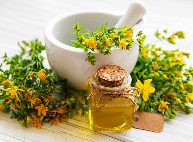 Bottles with St John wort extract on the wooden table